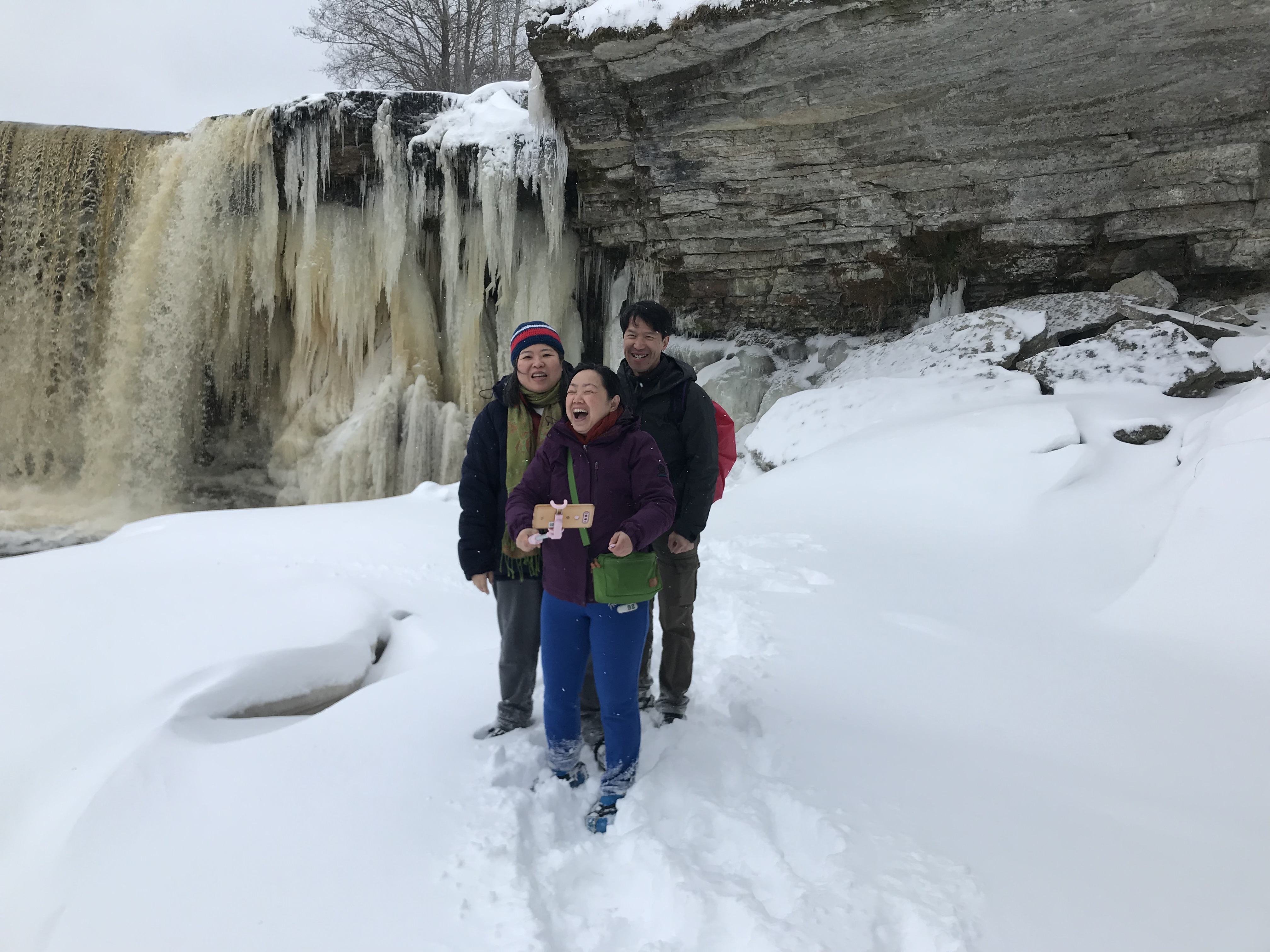 Our happy clients posing next to the frozen Jägala Waterfall Our happy clients posing next to the frozen Jägala Waterfall