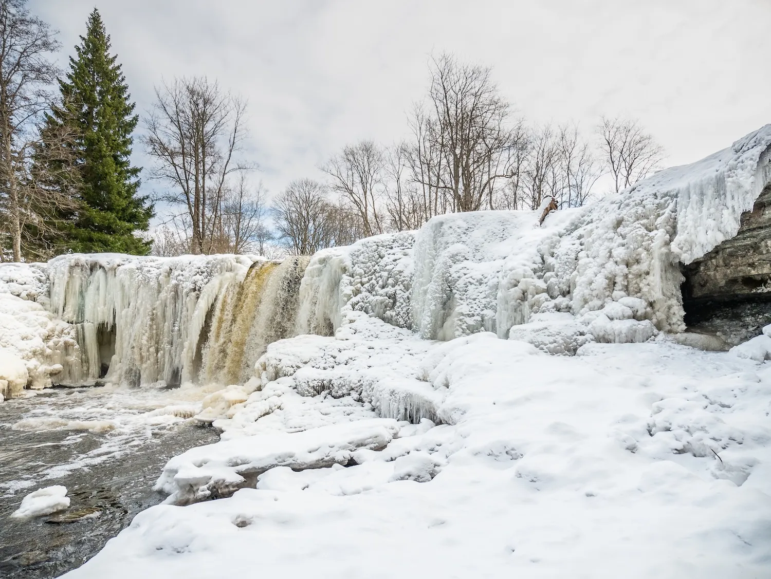 Keila Waterfall covered in snow and ice during winter in Estonia