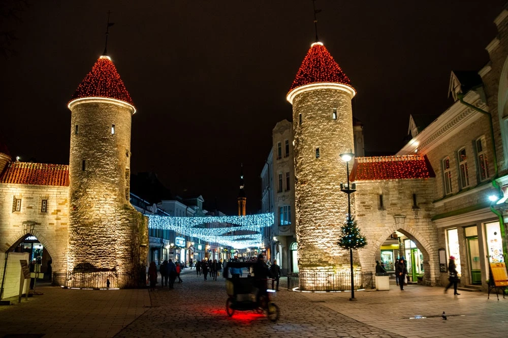 Tallinn Old Town decorated with festive lights during dark winter weather in Estonia.
