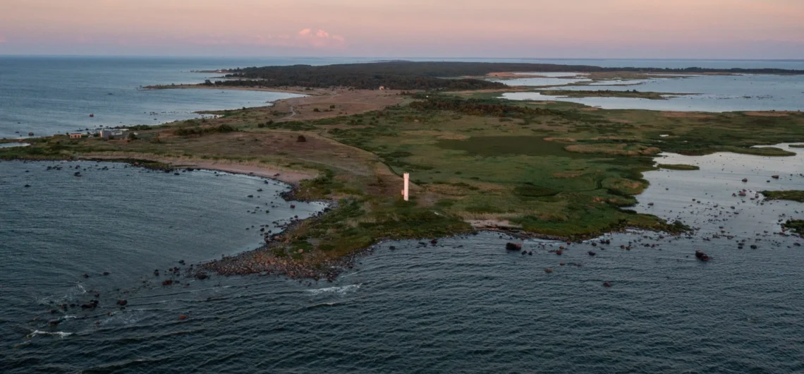 Drone view of Prangli Island coastline with lighthouse and coastal meadows