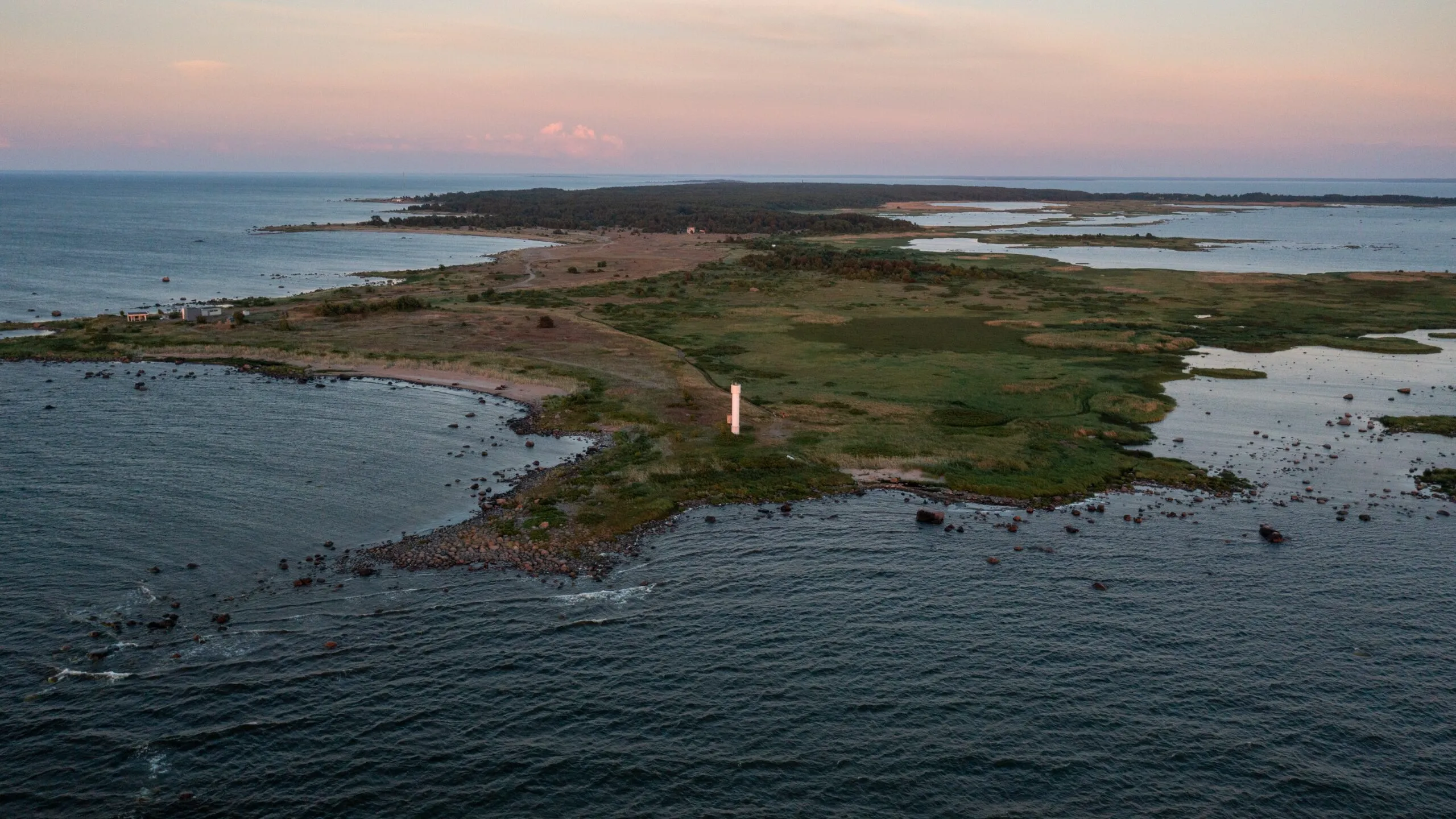 Drone view of Prangli Island coastline with lighthouse and coastal meadows