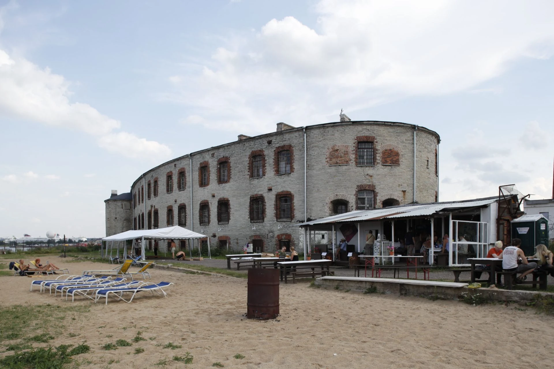 Patarei sea fortress and former Soviet prison in Tallinn, with sun loungers and a summer beach bar in front