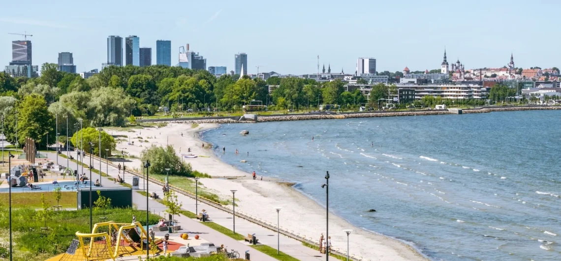 Reidi tee seaside promenade and beach in Tallinn with city skyline views on a sunny day