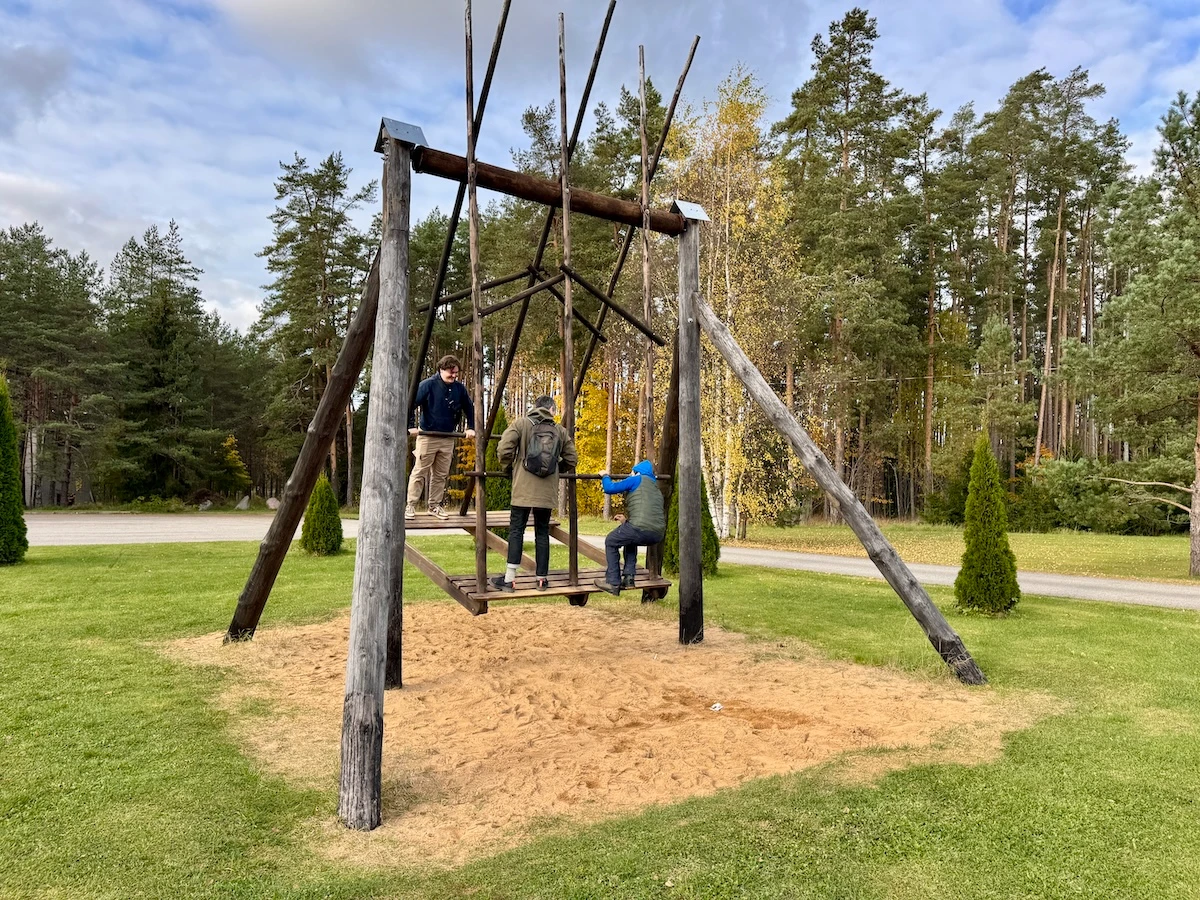 Visitors trying a traditional Estonian village swing in Viitna, a cultural stop often included in Lahemaa National Park tours.