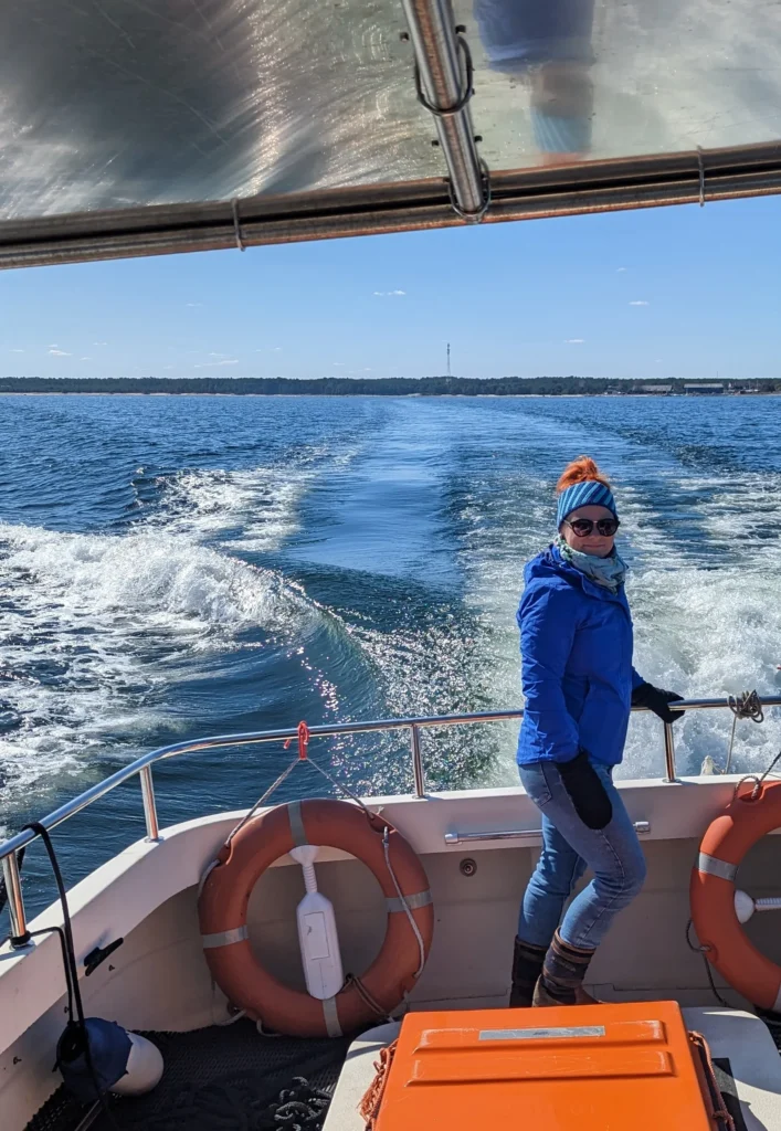 Helen, tour guide at Prangli Travel, standing on a boat on the Baltic Sea in Estonia