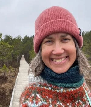 Portrait of Diana, Tallinn Day Trip guide, smiling on a bog boardwalk in Estonia