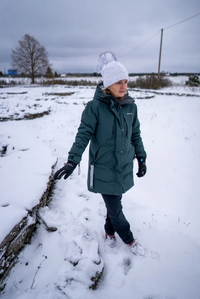 Nele, tour guide at Prangli Travel, walking through a snowy winter landscape in Rebala, Estonia